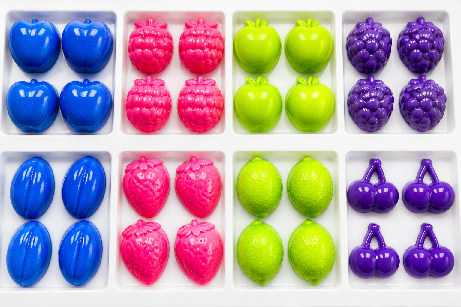 Glossy industrial colour capsules on a white production tray